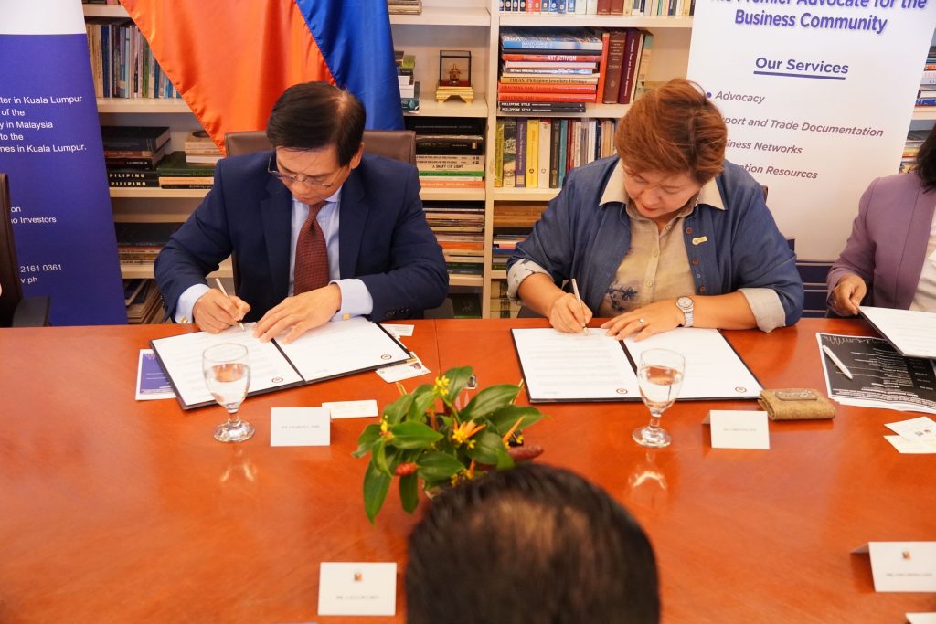 Ambassador Jose and MICCI President, Ms. Christina Tee, sign the MOU